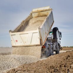Dump truck delivering gravel to a residential driveway Gravel Today Olympia Washington