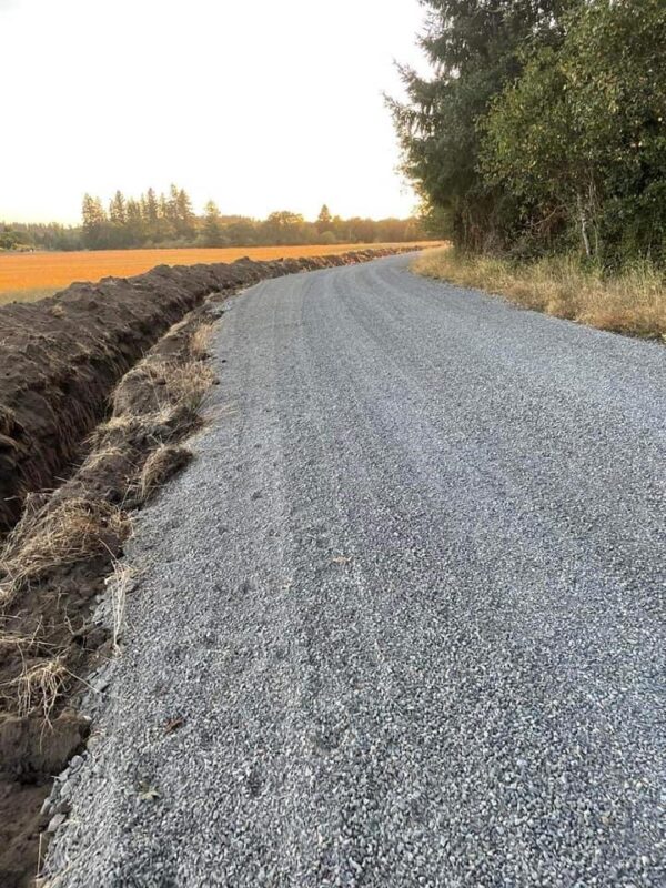 Dump truck delivering gravel to a residential driveway